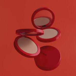 Könnte beinhalten: Rote Kompakt-Make-ups mit Spiegel und hellbraunem Puder. Die Kompakte sind geöffnet und geschlossen, mit dem Wort "BEAUTY" auf einem gedruckt. Der Hintergrund ist einfarbig rot.