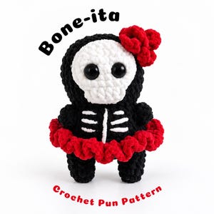 May include: A crochet amigurumi figure featuring a black and white skeleton design with a red ruffled skirt and a red flower accessory on its head. The text Bone-ita and Crochet Pun Pattern are printed in black and red above and below the figure.