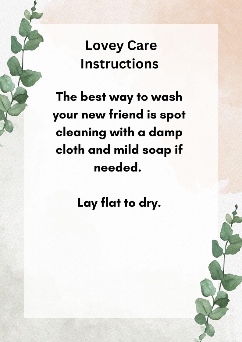 May include: A white card with black text outlining care instructions for a lovey. The text reads "Lovey Care Instructions. The best way to wash your new friend is spot cleaning with a damp cloth and mild soap if needed. Lay flat to dry."