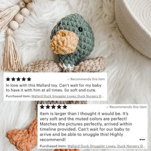May include: A handmade crochet duck toy in shades of green, tan, and yellow. The duck has a textured body, a yellow beak, and small black eyes. The toy is designed to be a baby lovey. The text in the image says "Mallard Duck Snuggler Lovey".