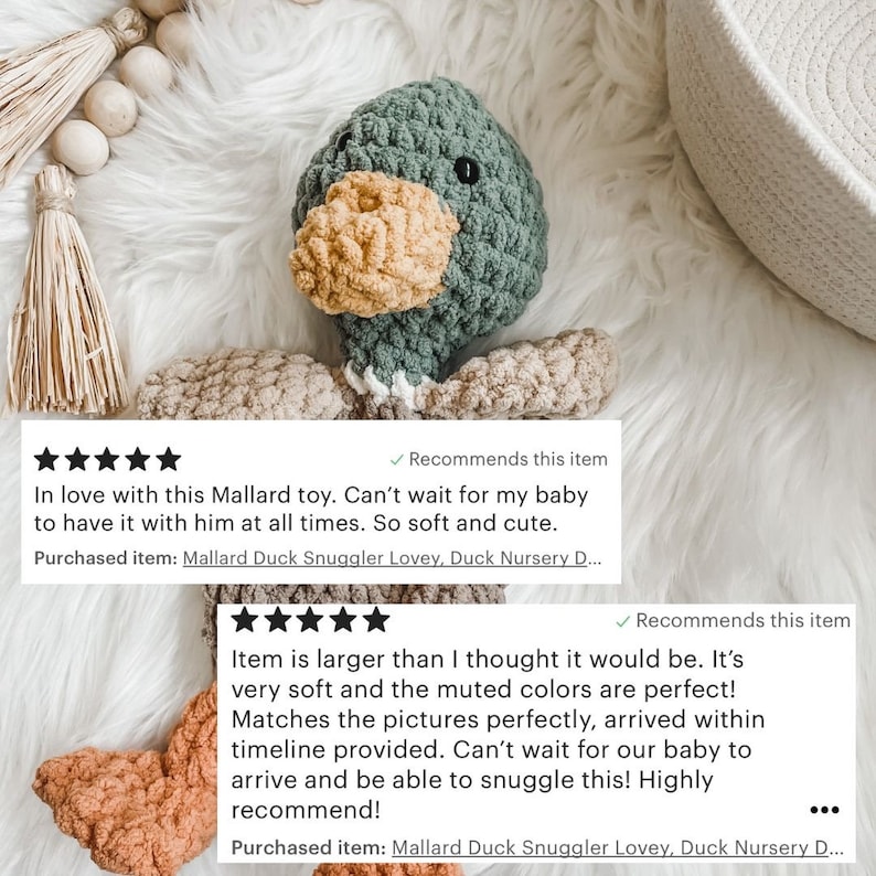 May include: A handmade crochet duck toy in shades of green, tan, and yellow. The duck has a textured body, a yellow beak, and small black eyes. The toy is designed to be a baby lovey. The text in the image says "Mallard Duck Snuggler Lovey".