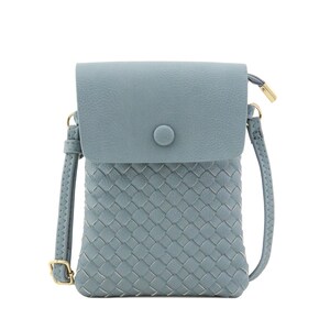 May include: A light blue woven crossbody bag with a flap closure and a gold button. The bag has a long adjustable strap.