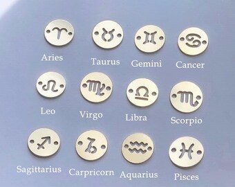 May include: Twelve gold-colored metal charms, each featuring a different zodiac symbol. The symbols are Aries, Taurus, Gemini, Cancer, Leo, Virgo, Libra, Scorpio, Sagittarius, Capricorn, Aquarius, and Pisces.