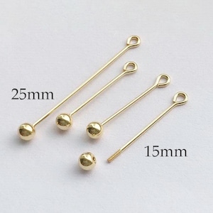May include: Four gold-colored head pins with loops at the top. The head pins are 25 mm and 15 mm in length.
