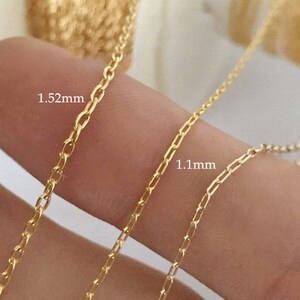 May include: Two gold chains, one 1.52 mm thick and the other 1.1 mm thick, are shown side-by-side on a finger.