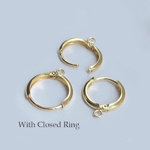 May include: Three gold-toned hoop earrings with a closed ring. The earrings are on a white background.