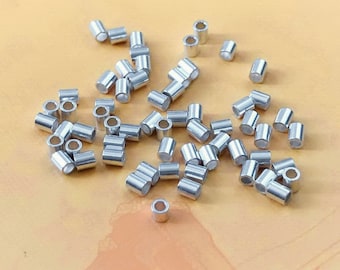 May include: A large quantity of silver jump rings, which are small metal rings used for connecting jewelry components.