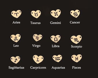May include: Twelve gold heart-shaped charms with zodiac symbols. The symbols are Aries, Taurus, Gemini, Cancer, Leo, Virgo, Libra, Scorpio, Sagittarius, Capricorn, Aquarius, and Pisces.