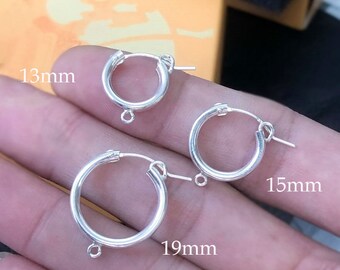 May include: Three silver hoop earrings of different sizes, 13mm, 15mm, and 19mm.