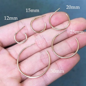May include: Five gold hoop earrings of different sizes, displayed on a hand. The earrings are labeled with their diameter in millimeters: 12mm, 15mm, 20mm, 25mm, and 30mm.