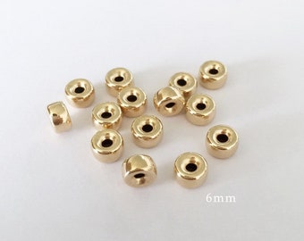 May include: A group of 16 gold-colored metal beads, each with a hole in the center. The beads are 6 mm in diameter.