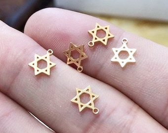 May include: Five gold-colored metal charms in the shape of a six-pointed star, also known as the Star of David.