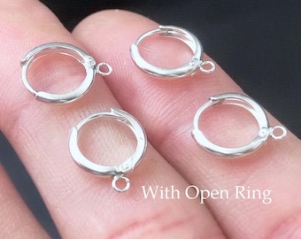 May include: Four small, silver-colored hoop earrings with open rings for attaching charms or other embellishments. The earrings are round and have a simple, classic design. The text "With Open Ring" is visible in the image.