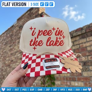 May include: A cream-colored baseball cap with red embroidered text that reads i pee in the lake surrounded by small star icons. The brim features a red and white checkered pattern. A sticker on the brim reads OTTO and a tag reads MINOSHStudio.