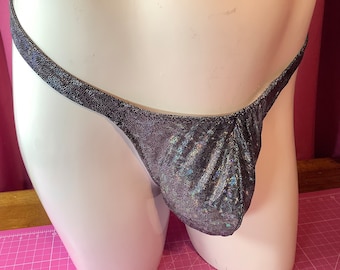 May include: A black and silver shimmery thong with a low rise cut.