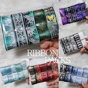 May include: Assortment of decorative ribbon packs in various colors and patterns. Designs include butterflies, floral, geometric, and celestial motifs. The text "RIBBON PACKS" is visible.