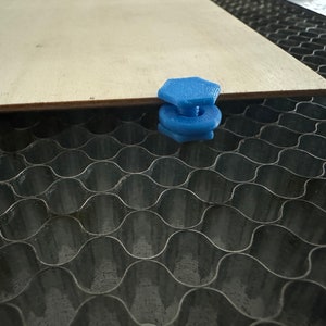 May include: A blue plastic honeycomb spacer for a CNC machine. The spacer is used to elevate a piece of wood above the honeycomb surface.