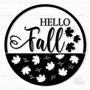 May include: Black and white round sign with the text "Hello Fall" in a decorative font. The bottom half of the sign is filled with a pattern of black maple leaves.