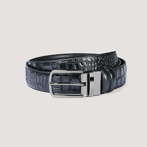 May include: A black belt with a crocodile-skin texture. The belt has a silver-coloured rectangular buckle. The belt is curved and appears to be made of leather. A classic accessory.