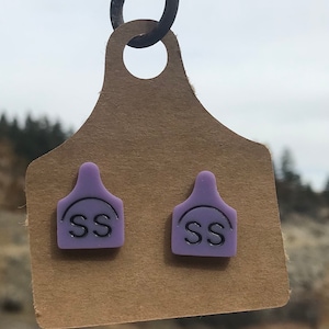 Brand cow tag stud earrings.