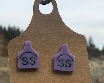 Brand cow tag stud earrings.