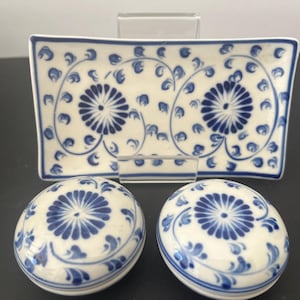 May include: A set of three ceramic dishes with a blue and white floral pattern. The dishes are a rectangular serving tray and two round bowls.