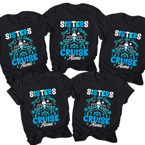 May include: Set of five black t-shirts with a white and blue graphic print. The graphic features a cruise ship with the text "Sisters Don't Let Sisters Cruise Alone".