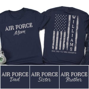 May include: Navy blue t-shirts with the text "AIR FORCE Mom" on the front and a distressed American flag design on the back. The back of the shirt also has the name "WILLIAMS" and "324 TRS/ FLT 650 KNIGHTS". Additional shirts say "AIR FORCE Dad", "AIR FORCE Sister", and "AIR FORCE Brother".