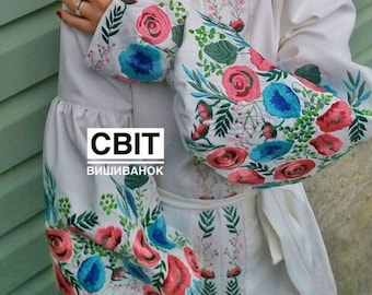 May include: White embroidered blouse with a floral pattern in pink, blue, and green. The text "СВІТ ВИШИВАНОК" is printed on the front of the blouse.