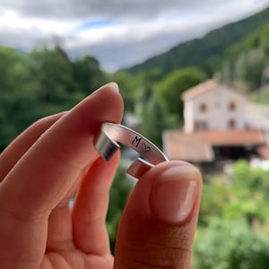 May include: A silver ring with the letter "M" and a heart engraved on it.