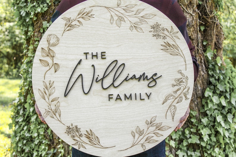 Custom wood last name family sign with wedding year and engraved floral wreath by Heritage Sign Co. Makes for a perfect wedding, engagement, birthday and Christmas gift. Multiple sizes, styles, stains and letter colors available.