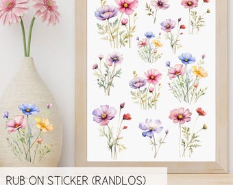 May include: A sheet of colorful rub-on stickers featuring watercolor illustrations of pink, purple, and blue cosmos flowers. The stickers are labeled "RUB ON STICKER (RANDLOS)" and "ANWENDBAR AUF GLAS. KERAMIK, HOLZ. KUNSTSTOFF, METALL ETC."