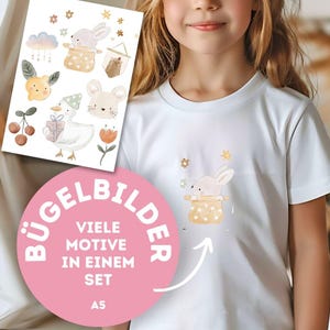 Könnte beinhalten: Ein weißes T-Shirt mit einer Illustration eines Hasen in einem Hut und Sternen. Ein Bogen mit passenden Bügelbildern mit verschiedenen Tier- und Blumendesigns ist sichtbar. Der Text "BÜGELBILDER" und "VIELE MOTIVE IN EINEM SET" ist ebenfalls vorhanden.