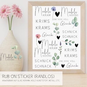 Könnte beinhalten: Ein Set mit 10 Rub-on-Stickern mit verschiedenen Designs, darunter Blumen, Herzen und der Text "Madels Kram", "Madels Gedons", "Krims Krams", "Schnick Schnack" und "Eine Dose Voll Glück".