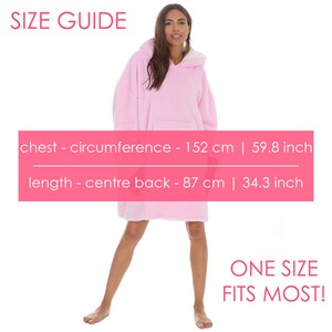 May include: A pink oversized hoodie with a hood and a kangaroo pocket. The size guide shows the chest circumference is 152 cm and the length is 87 cm. The text "ONE SIZE FITS MOST!" is displayed at the bottom of the image.