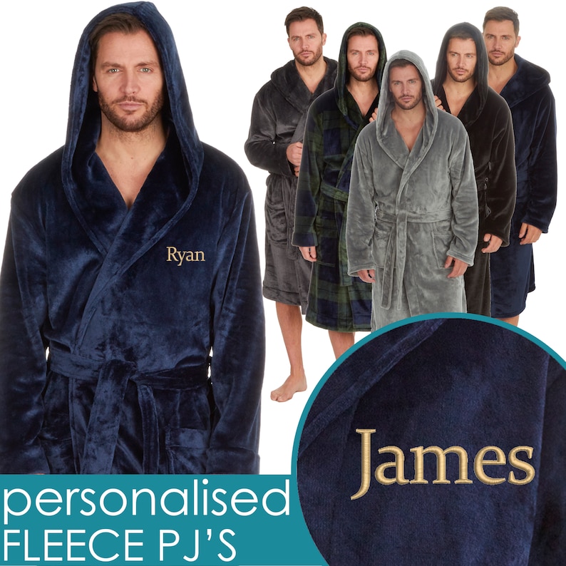 May include: A navy blue hooded robe with a personalized name embroidered on the front. The robe is made of soft fleece and has a tie belt. The image shows multiple robes in different colors, including gray, black, and green.