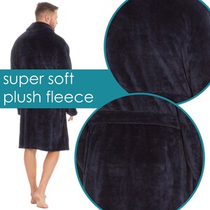 May include: A navy blue plush fleece robe with a shawl collar and a tie belt. The robe is soft and comfortable, perfect for lounging around the house.