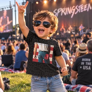 May include: A black t-shirt with a graphic print of the Born in the U.S.A. album cover featuring a person in blue jeans and a white shirt against an American flag background, worn with black sunglasses and blue denim jeans.