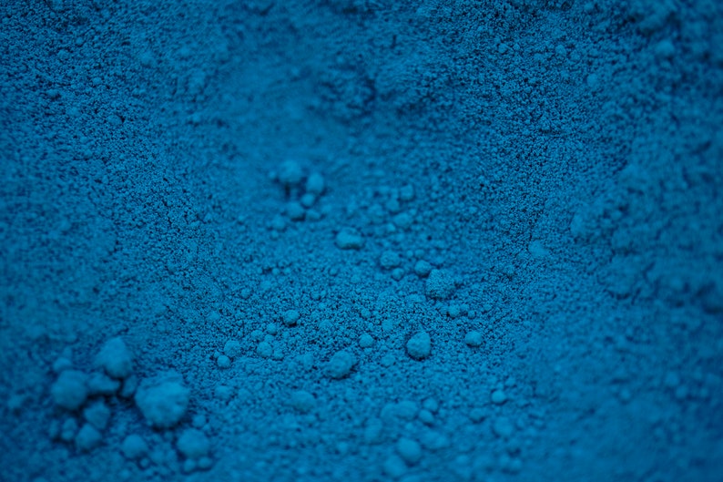 May include: Close-up of a blue powder with a grainy texture.