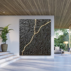May include: Abstract art painting with a black textured background and a single gold crack running through the center.