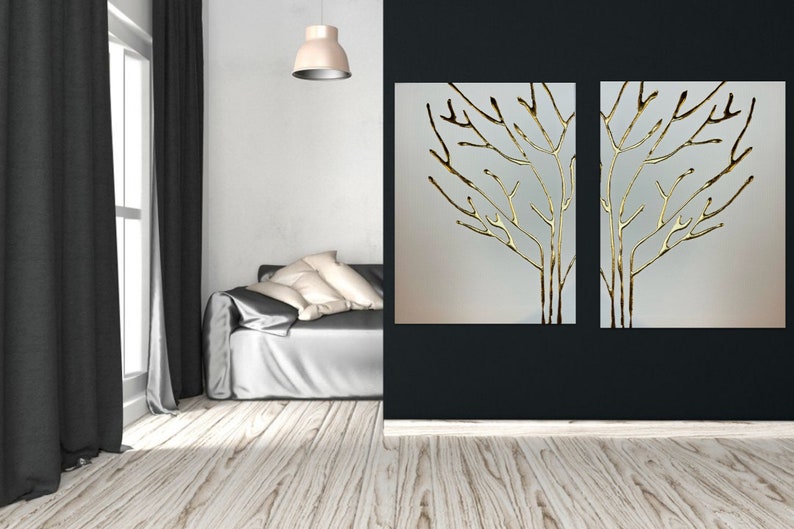 May include: Two gold leaf tree branch wall art pieces on a white background. The art is framed and hung on a black wall.