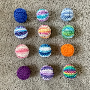 Knitted cat balls in various colors sold in sets of 3