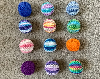 Knitted cat balls in various colors sold in sets of 3