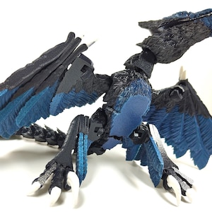 May include: A detailed, articulated dragon figurine with a black and blue color scheme. The dragon has large wings, sharp claws, and a detailed head. The wings and chest feature a vibrant blue color, contrasting with the black body.