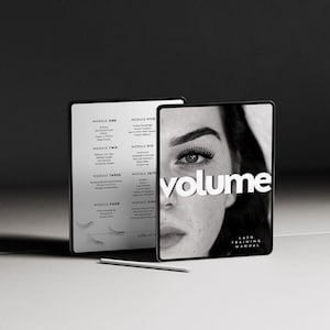 May include: Two tablets are shown in a black and white image. One displays a table of contents, and the other shows a woman's face with the word "volume" and the text "Lash Training Manual". A stylus pen is on the surface.