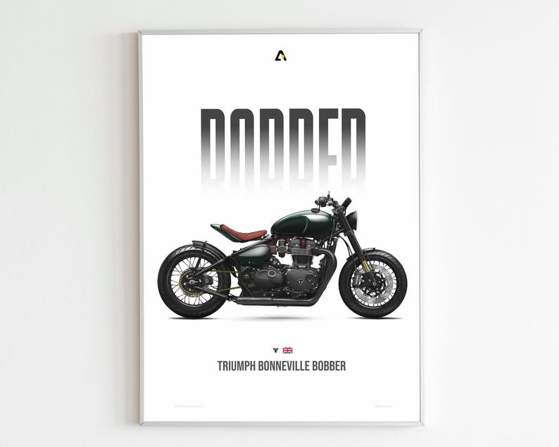 May include: A framed print featuring a dark green Triumph Bonneville Bobber motorcycle. The word "BOBBER" is printed in large, bold, gray letters above the motorcycle. The text "TRIUMPH BONNEVILLE BOBBER" is printed below the motorcycle.