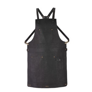 May include: A black canvas apron with adjustable straps, multiple pockets, and brass rivets.