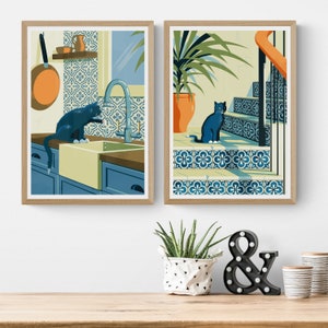 Living room with 2 posters on the wall. The illustrations on the art print shows a black cat with azulejo tiles as can often be found in Spain and Portugal. The artwork gives a Mediterranean feel.