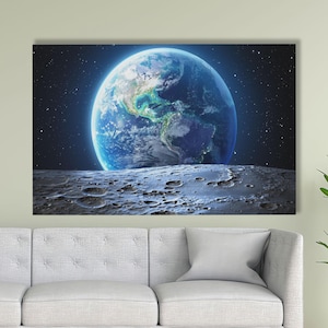 May include: A canvas print showing planet Earth as seen from space, with a detailed view of the continents and oceans. The image shows the Earth's blue and green surface against a starry background, with a textured lunar surface in the foreground.