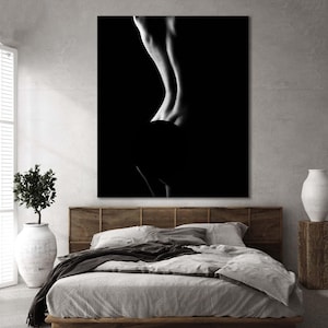 May include: Black and white photograph of a person's back, with the subject's body outlined against a dark background.
